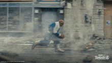 a man is running down a street with a fantastic 4 logo on the bottom