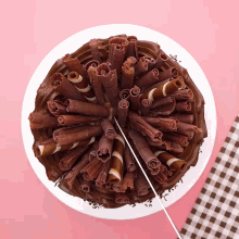 a chocolate cake with chocolate shavings on it and a slice taken out of it