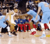 a group of basketball players are playing a game on a court . one of the players has the number 10 on his jersey .
