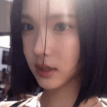a close up of a woman 's face with her hair visible
