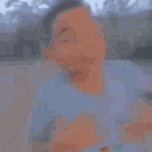 a blurry picture of a man standing on a beach .
