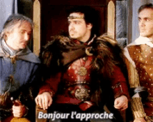 a man in a fur coat sits on a throne with the words bonjour l'approche below him