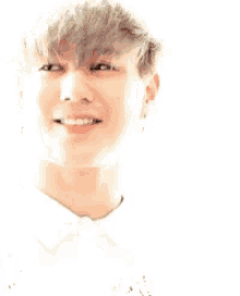 a close up of a person 's face with a white shirt and tie smiling .