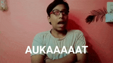 a man wearing glasses and a t-shirt that says aukaaaat