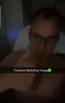 a man with glasses is giving a thumbs up with the words turizmus marketing vizsga
