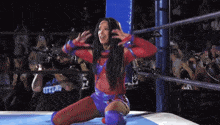 a woman in a wrestling ring has a shirt that says strong on it