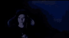a dark room with a blue light coming from the ceiling