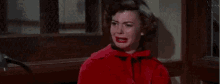 a woman in a red coat is sitting on a bench and saying `` i don 't know ... '' .