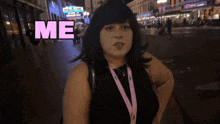 a woman is standing in front of a sign that says " me "