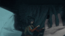 a person 's hand is reaching out towards a person in the dark