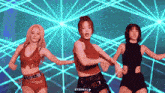 three women are dancing in front of a blue background and the word eternal is on the bottom