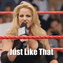 a woman in a wrestling ring is holding a microphone and the words just like that are below her