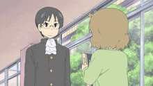 a man and a woman are standing in front of a window
