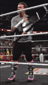 a man in a wrestling ring holding a hammer with the word strikes on it