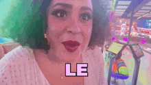 a woman in a bowling alley with the word le on her face
