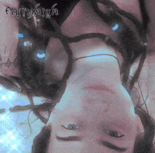 a woman with dreadlocks is laying upside down with the word fairyhigh above her head