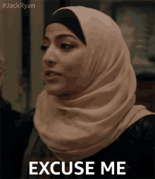 a woman in a hijab says " excuse me " in front of her face