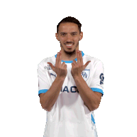 a man wearing a white shirt with a blue collar that says ac on it