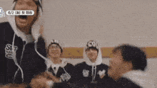 a group of people are playing a game in a room while wearing headbands .