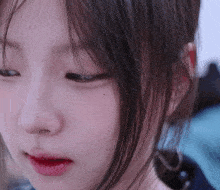 a close up of a woman 's face with a red lip