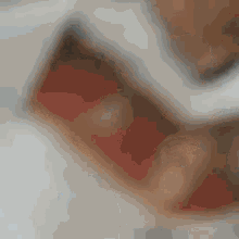 a close up of a person 's teeth with red spots