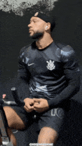 a man wearing a black shirt with the number 10 on it