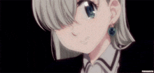 a close up of a girl wearing earrings and a collar .