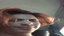 a close up of a woman 's face with red hair