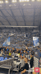 a crowd of people in a stadium with a gif maker logo