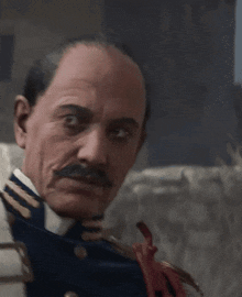 a man with a mustache wearing a blue uniform