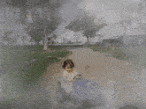 a little girl is driving a blue toy car with a quote from kitaro nishida