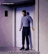 a man in a star trek uniform is standing in front of an elevator and saying i 'm in control of my emotions