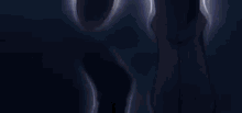 a man is holding a sword in his hand while standing on top of a cliff .
