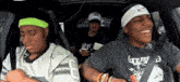 three people in a car with one wearing a headband with the letter s on it