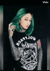 a woman with green hair is wearing a t-shirt that says " moflbeck " on it