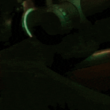 a man in a cowboy hat is holding a rifle in a dark room