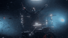 a man playing drums in a dark room