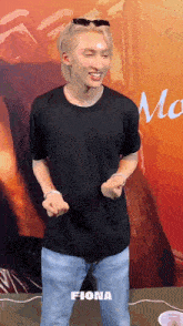 a man wearing sunglasses and a black shirt with the name fiona on the bottom