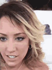 a close up of a woman 's face with blonde hair