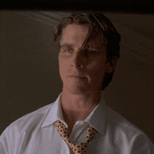 a close up of a man wearing a white shirt and a tie