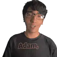 a man wearing glasses is wearing a shirt that says adam