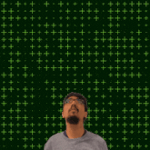 a man stands in front of a green background with the number 21