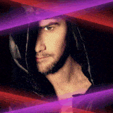 a man with a beard wearing a black hood