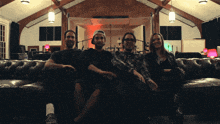 a group of people sitting on a couch in a room