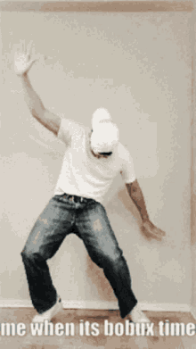 a man is dancing in front of a wall with the words me when its bobux time