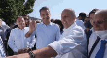 a group of men are standing in a crowd and one man is pointing