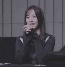 a woman with long hair is making a peace sign