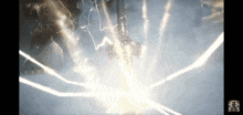 a person is holding a lightning bolt in their hand in a dark room .