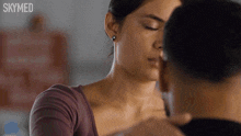 a man and a woman are kissing and the words skymed are on the bottom