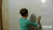 a child is writing on a whiteboard with the word coub on the bottom right